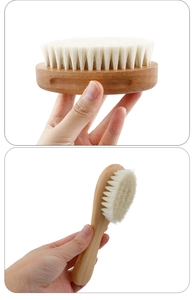 Detailed close-up of a soft wool baby brush with a smooth natural beech wood handle