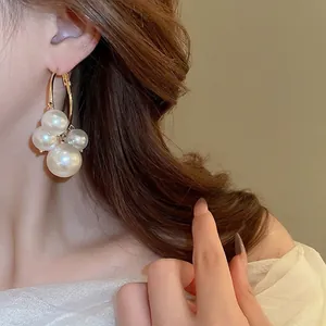 Elegant gold hoop earrings with white pearls in a minimalist retro French style for women