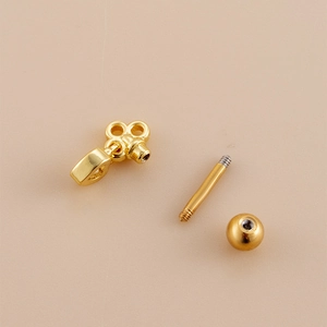 Golden stainless steel spider web heart cartilage stud with screw-back and keyhole pendant