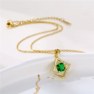 Gold stainless steel necklace featuring a square green gemstone pendant with zircon accents