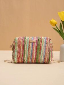 Detail of colorful woven straw camera bag with gold chain strap and metallic closure