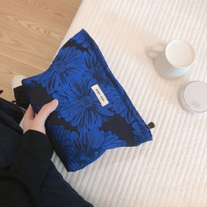 Blue floral jacquard makeup bag with sunflower pattern and simple wish textile label