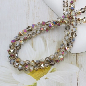 Macro shot of 6mm champagne faceted crystal glass beads with iridescent rainbow finish