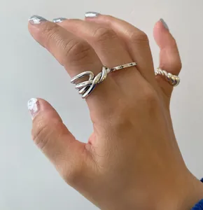 Detailed view of three 925 silver stacked rings with twisted and engraved patterns