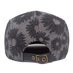 Detail of denim daisy beret back featuring adjustable metal buckle and floral jacquard