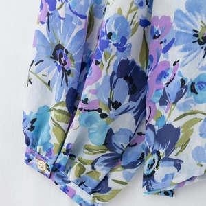 Floral chiffon blouse featuring blue and purple print with buttoned cuff details