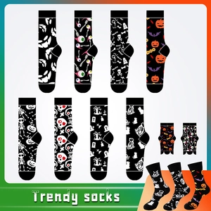 Detail view of Halloween crew socks featuring diverse spooky patterns like pumpkins and ghosts