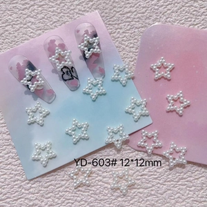 Detailed view of white resin pearl star nail charms with model YD-603 and 12mm size