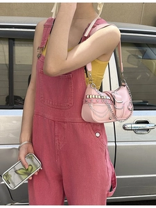 Pink Y2K shoulder bag with silver chains, star studs, and metallic heart charms on a model