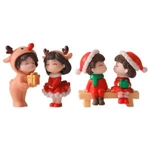 Set of four resin Christmas figurines including reindeers and Santa couple on white background