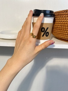 Close-up of polished gold-plated s925 silver droplet wrap ring on hand with aesthetic props