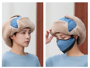 Detail view of winter trapper hat with mask, featuring blue fabric and khaki faux fur lining