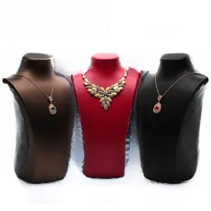Three elegant necklace display busts in dark brown, red, and black brushed leather finish