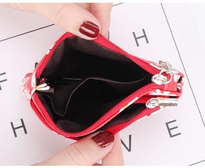 Close-up of red daisy floral coin purse showing double zipper and inner compartments
