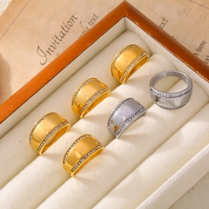 Set of six gold and silver titanium steel rings with rhinestones in a wooden jewelry box