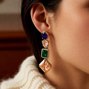 Detail of vintage square tassel earrings with multi-color zircon stones and gold metal