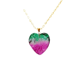 Rainbow heart-shaped crystal pendant necklace with golden chain on white background