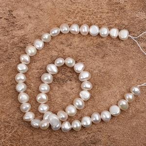 Natural 9-10mm white baroque freshwater pearls in a spiral layout on rock texture