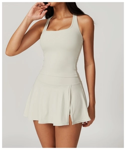 Detail of cream yoga set with square neck top and pleated skirt with side slits