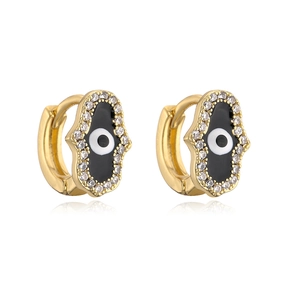 Detail of 18K gold Hamsa Hand earrings with enamel evil eye and zircon inlay