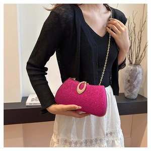 Model showing rose red glitter evening bag with gold chain and rhinestone clasp buckle