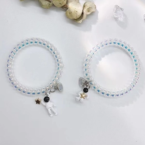Iridescent spiral telephone wire bracelets with 3D astronaut and star charm pendants