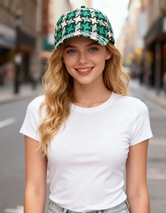 Detail of green houndstooth check baseball cap with textured wool blend fabric on model