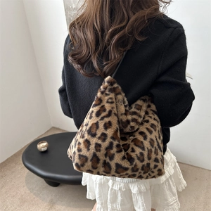 Fashionable leopard print plush tote bag for women worn over the shoulder in a lifestyle setting