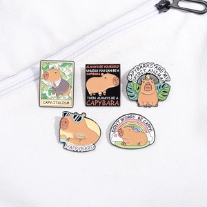 Cute capybara enamel pins set with funny puns and diverse cartoon designs on fabric