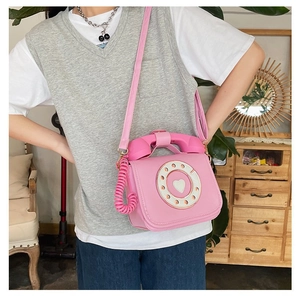 Creative pink retro telephone shaped crossbody bag with a cute heart dial design