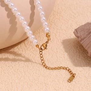 Close-up of 18K gold-plated lobster clasp and extension chain on pearl necklace