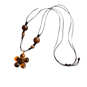 Maillard resin flower pendant necklace with amber texture and black leather rope cord