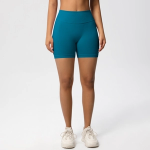 Close-up of seamless high waist compression waistband on teal fitness biker shorts