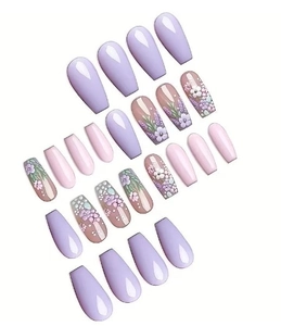 Detailed view of floral long coffin press-on nails in light purple and pink tones