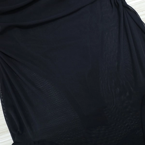 Detail of sheer black mesh fabric with delicate wavy trim for a summer mini dress
