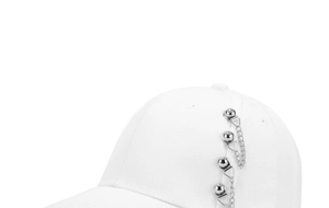 Close-up of a white cotton baseball cap featuring silver metal rings and hanging chains