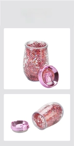 Detail view of 10oz double-wall egg-shaped tumbler with pink and red sequins and lid