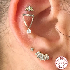 Macro detail of S925 sterling silver tassel earrings with crystals on an ear model