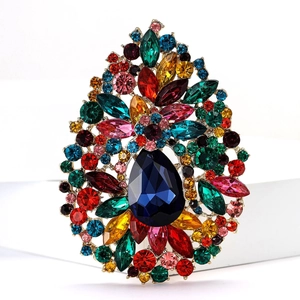 Detailed close-up of a large vintage teardrop brooch with colorful crystal rhinestones