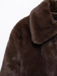Close-up detail of dark brown faux fur coat showing soft texture and collar craftsmanship
