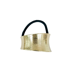 Detailed view of the gold alloy hair ring with textured surface and elastic band