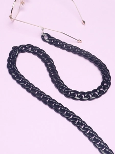 Minimalist black acrylic eyeglasses chain with thick flat links on purple background