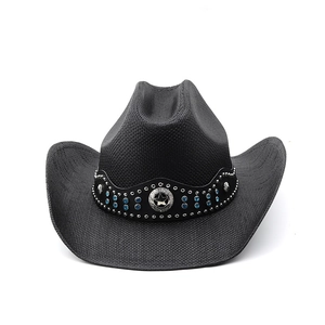 Detail of black cowboy hat with blue rhinestones and silver star metal emblem