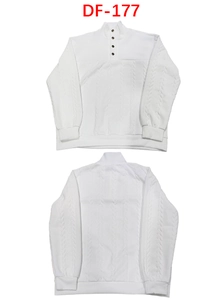 Detail view showing textured cable knit fabric and buttoned stand collar on a white sweater