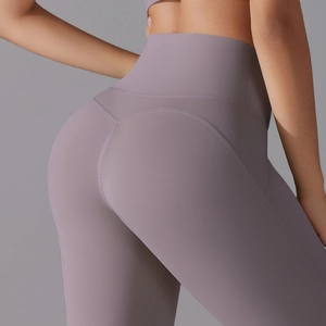 Close-up of V-shaped back stitching on lilac high-waisted yoga pants for peach hip effect