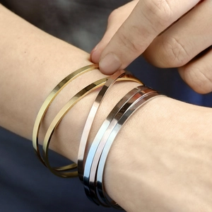 Polished minimalist stainless steel bangles set in gold, rose gold and silver finish