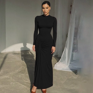 Detailed view of black slim fit maxi dress featuring waist ruching and stretchy fabric