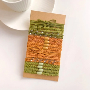 Detail of multi-color high elasticity hair ties set on a craft paper card with beads