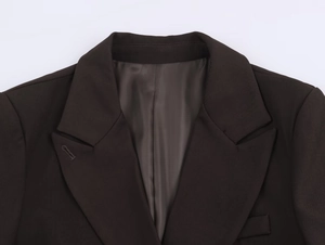 Detail of notch lapel and fine stitching on dark brown oversized women's blazer set