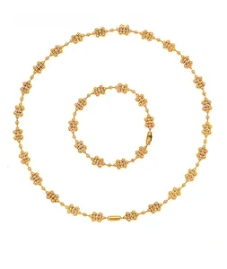 Close-up of 18k gold plated choker and bracelet set with delicate beaded flower clusters